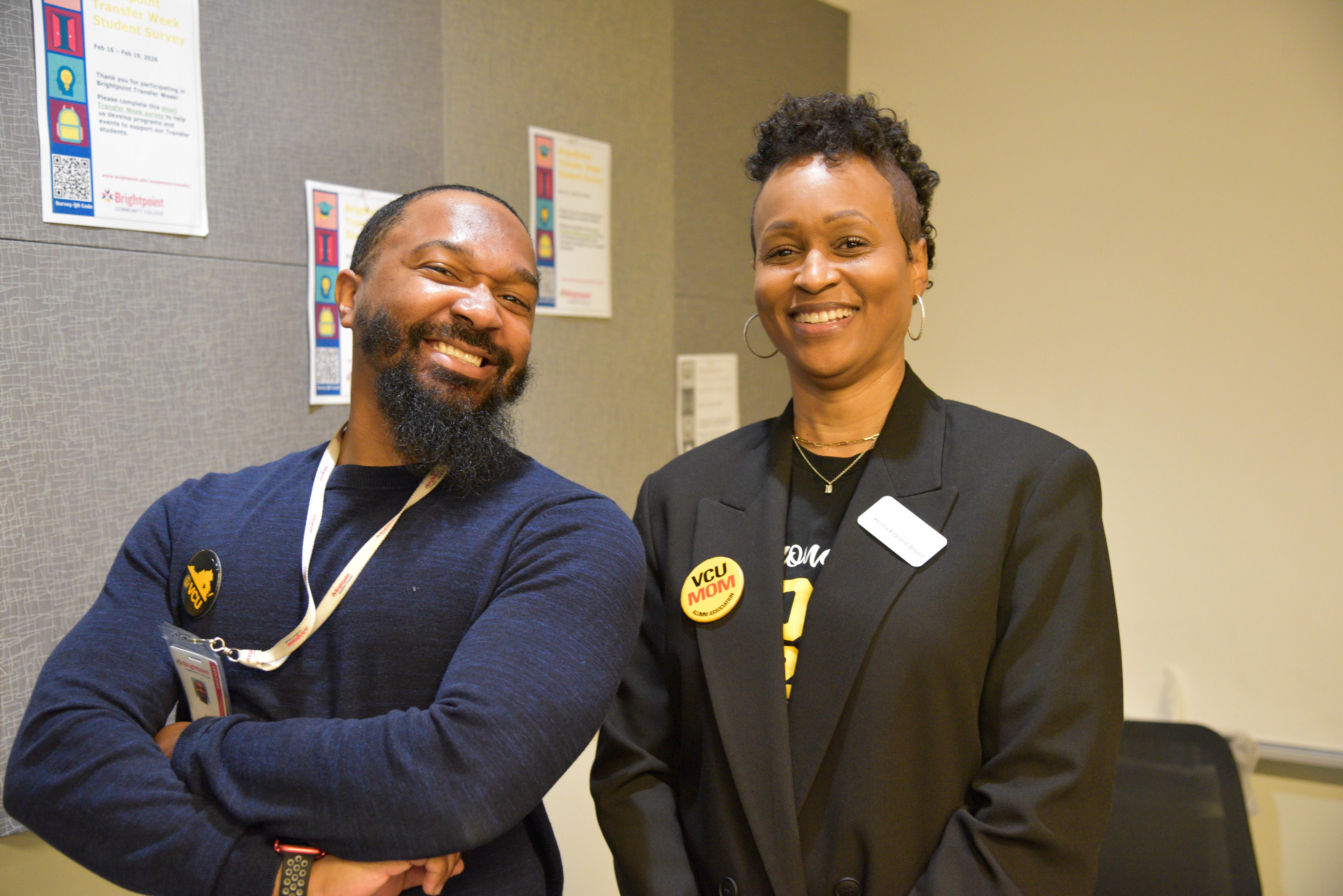 A Brightpoint advisor poses next to a VCU representative.