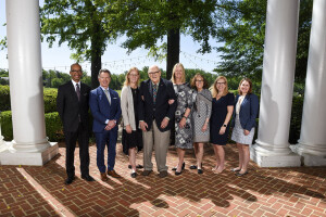 Group of people standing outside, smiling at the camera