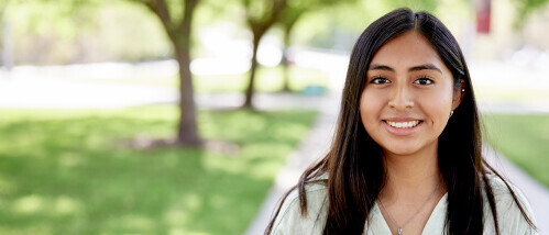 A Brightpoint student smiles confidently while standing outside on the college
