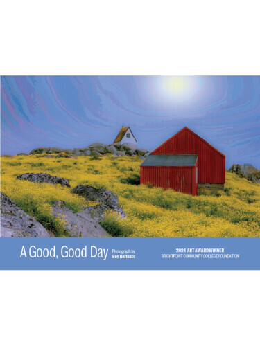 A photograph of a red barn in a sunny meadow. 