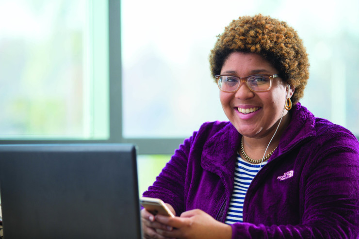 Smiling student with a laptop