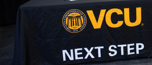 VCU NEXT STEP appears on a tablecloth over a table for a Brightpoint VCU NEXT UP event.