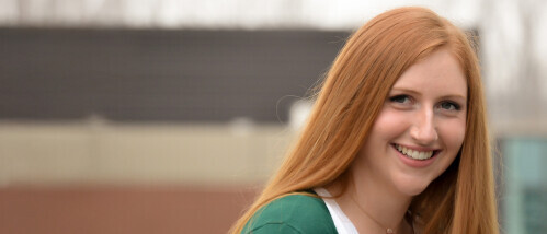 A person smiles at the camera on the Brightpoint campus