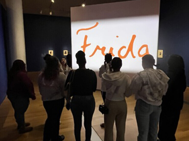 Students stand in front of the Frida Kahlo exhibition at the VMFA.