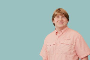 John Karlsen with a blue background behind him