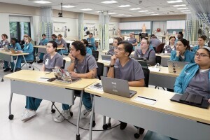 Nursing students listen attentively in bright classroom space on Brightpoint's Chester campus. 