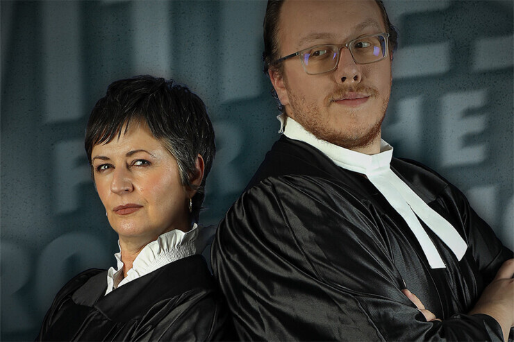 links to Two actors dressed in black robes, stand back to back.  One has a confident expression and the other a skeptical expression. 