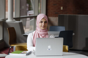 Student sitting with a laptop.