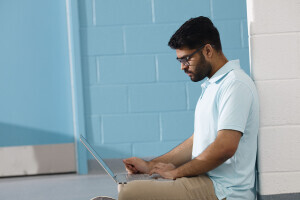 Student typing on laptop