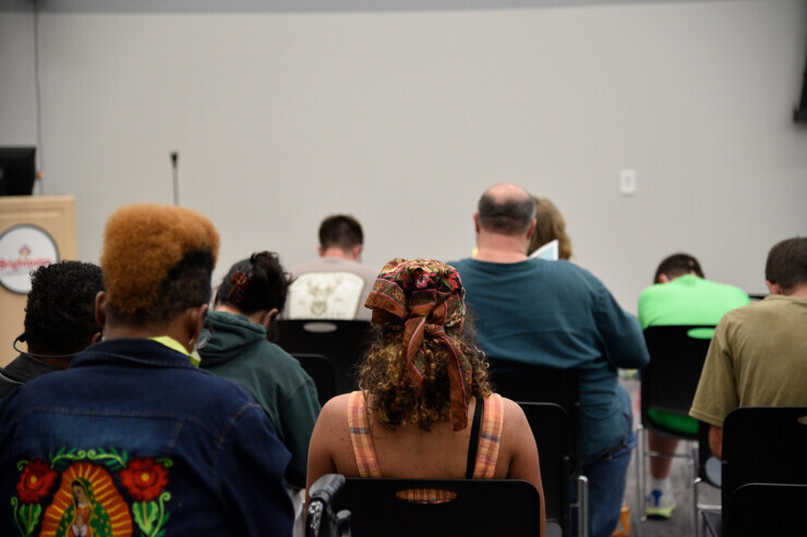links to Community members attending a meeting in the Brightpoint Nicholas Center.