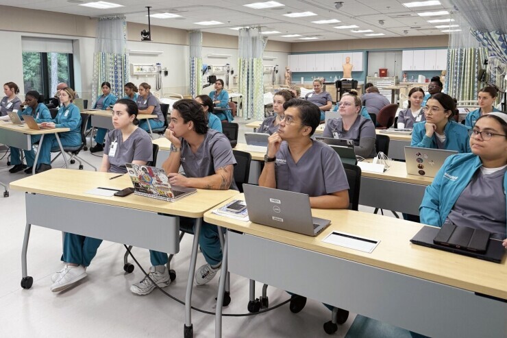 Nursing students listen attentively in bright classroom space on Brightpoint's Chester campus. 