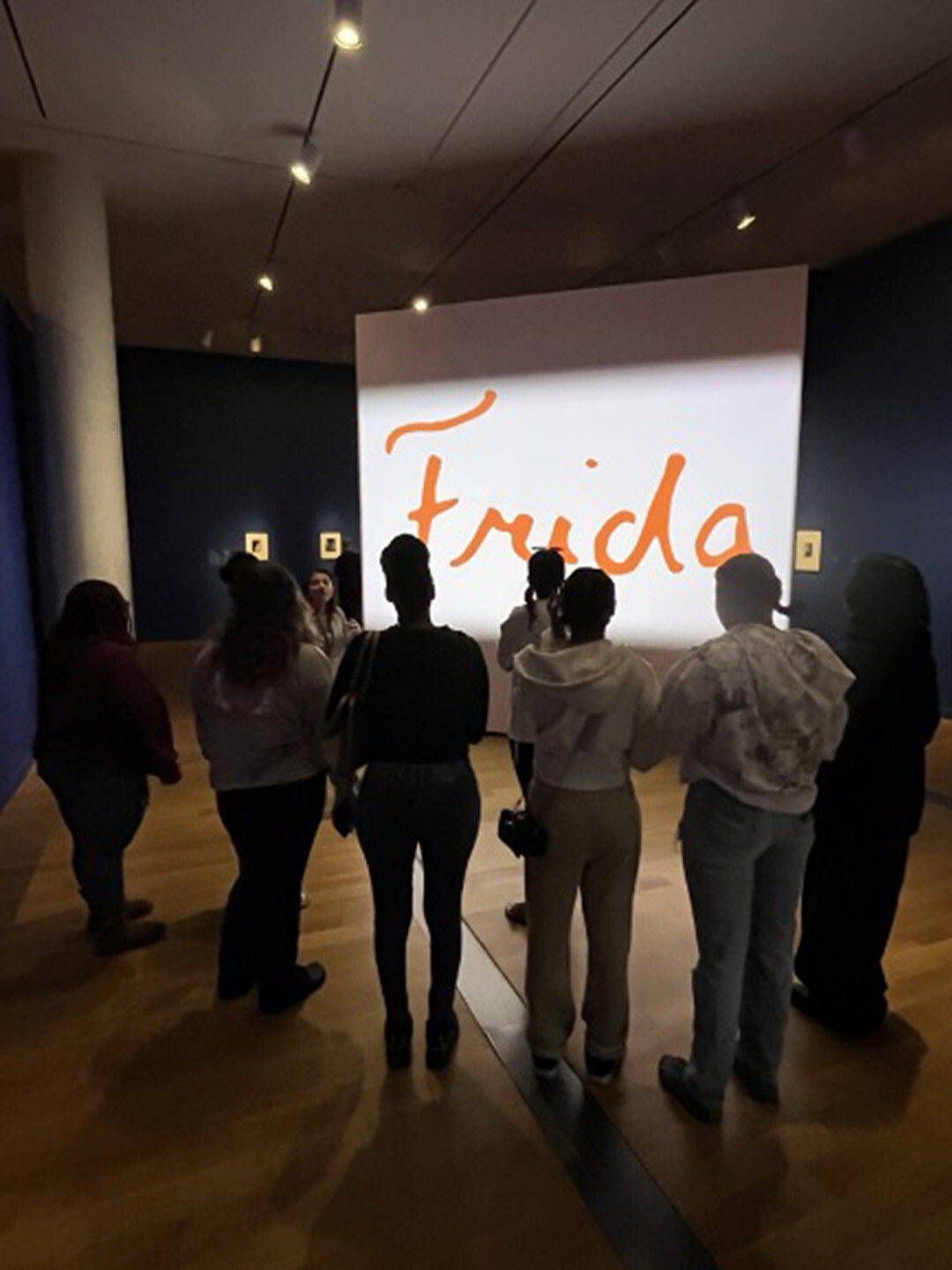 Students stand in front of the Frida Kahlo exhibition at the VMFA.