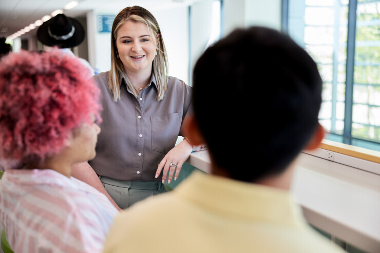 links to Three individuals have a lively conversation at the Midlothian Campus. 
